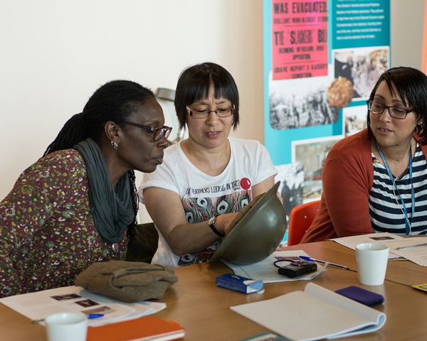 Workshop participants exploring objects relating to the history of West Indian soldiers