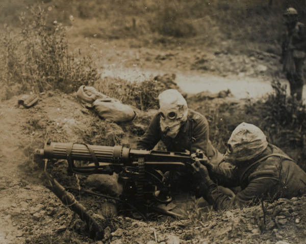 A Vickers machine gun team wearing gas masks, 1916