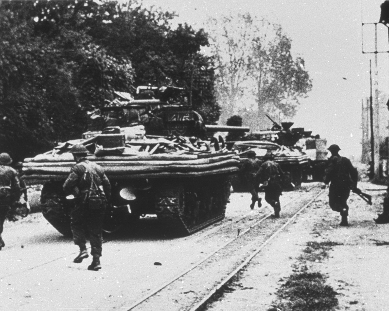 Amphibious Sherman tanks moving through Ouistreham, 6 June 1944