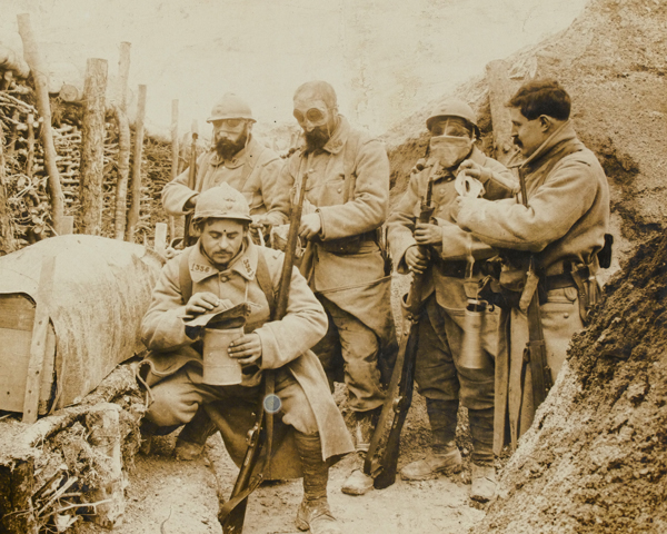 French troops don their gas masks while manning a trench, 1915