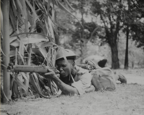 A King's African Rifleman covering a road, 1943 