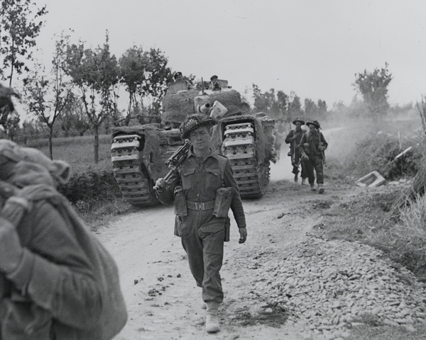 Infantry and a supporting Churchill tank advancing along the Argenta road, April 1945