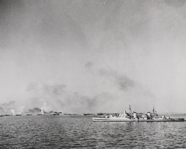 HMS ‘Spartan’ shells shore positions as landing craft approach, Anzio, 22 January 1944