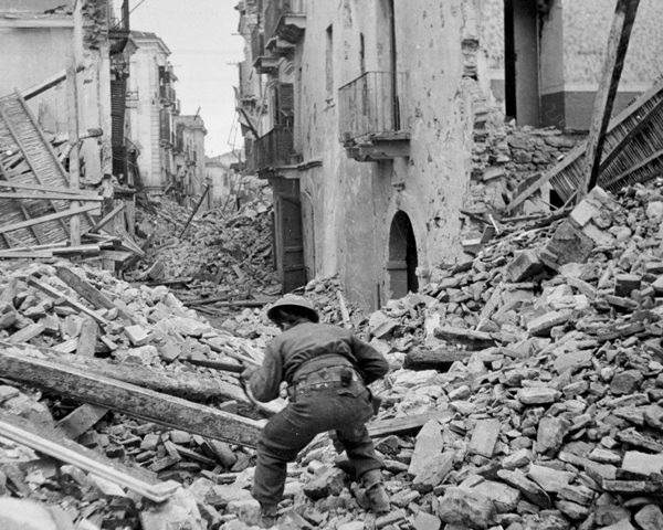 A Canadian infantryman searching the ruins of Ortona for snipers, 1943