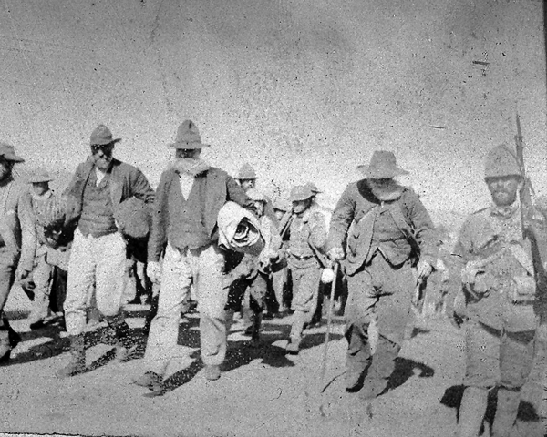 Boer prisoners escorted by a Durham Light Infantryman, c1901