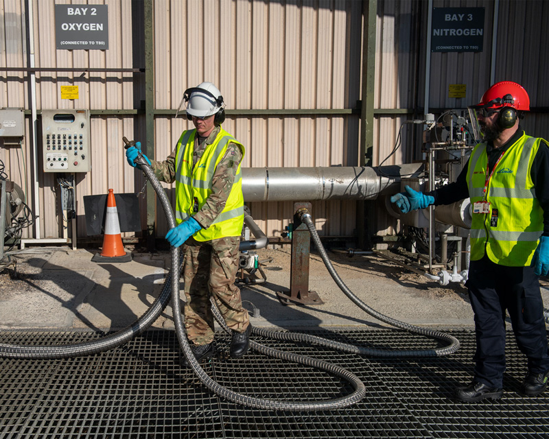 A Royal Engineer fills a tanker with oxygen for delivery to hospitals in London, March 2020