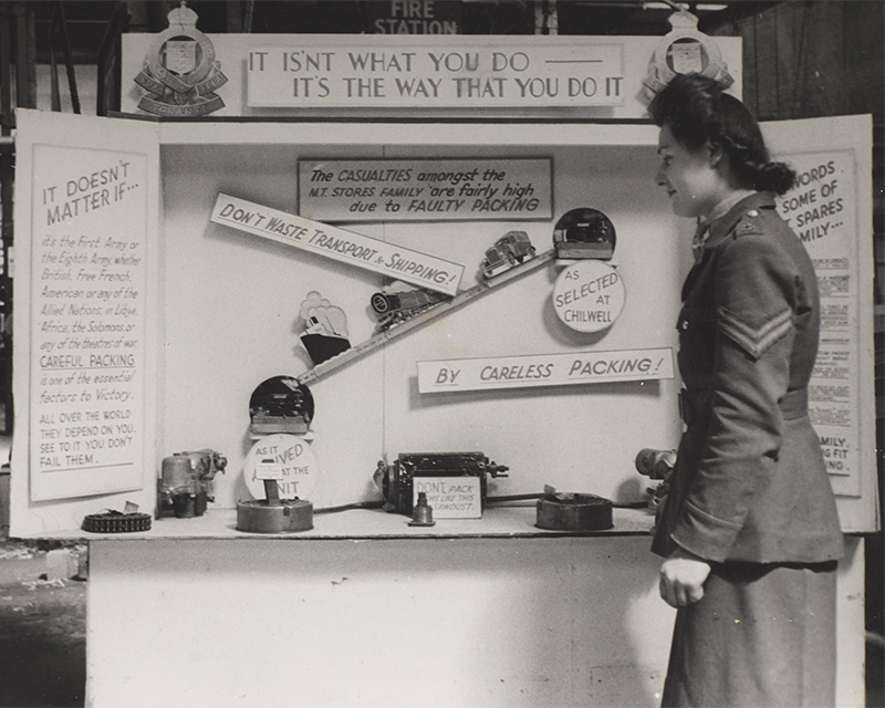 An ATS corporal inspecting an exhibition stand, Chilwell, 1943