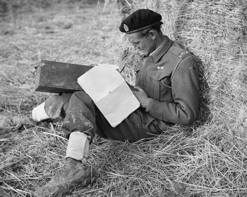 Major Oliver (Ollie) Woods MC filling in his unit’s war diary, Italy, c1943