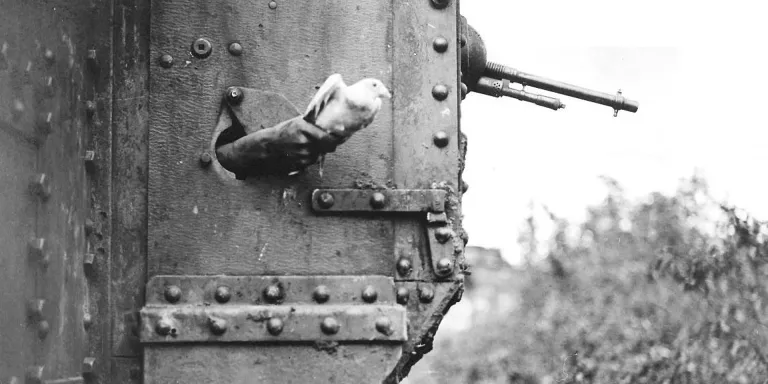  A messenger pigeon being released from the side of a British tank, 1918 © IWM (Q 9247)