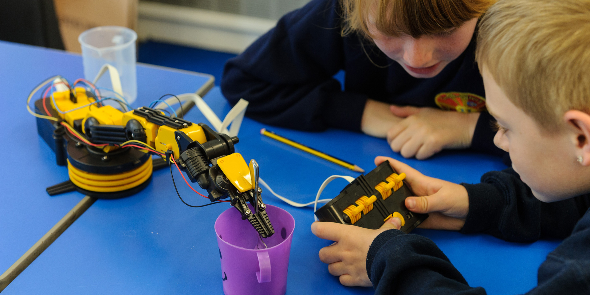 Students operate a robotic arm
