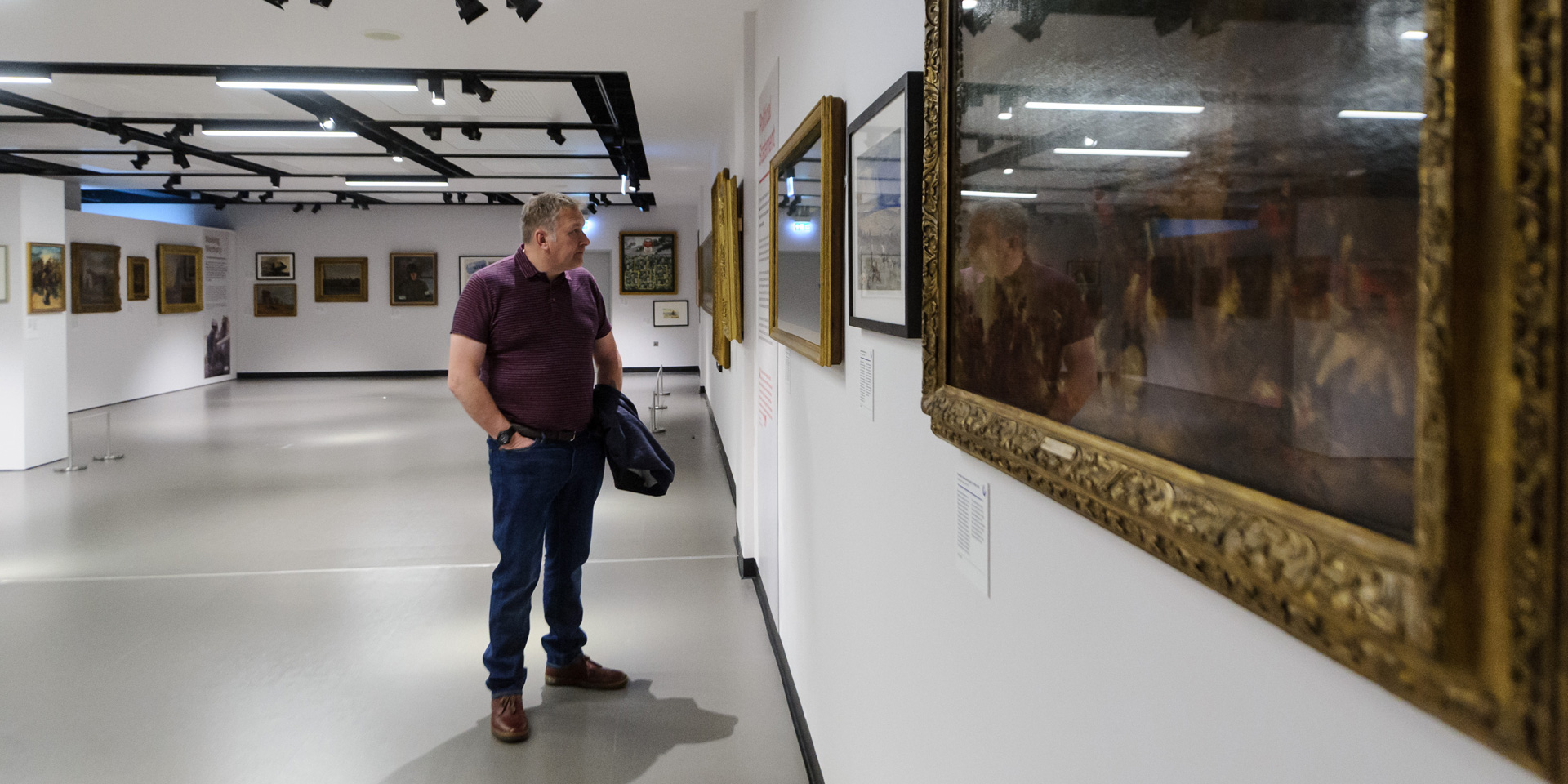 A visitor looks at painting in War Paint