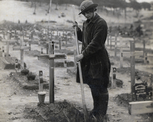 A member of the Women's Army Auxiliary Corps tends a graveyard at Etaples, 1918 