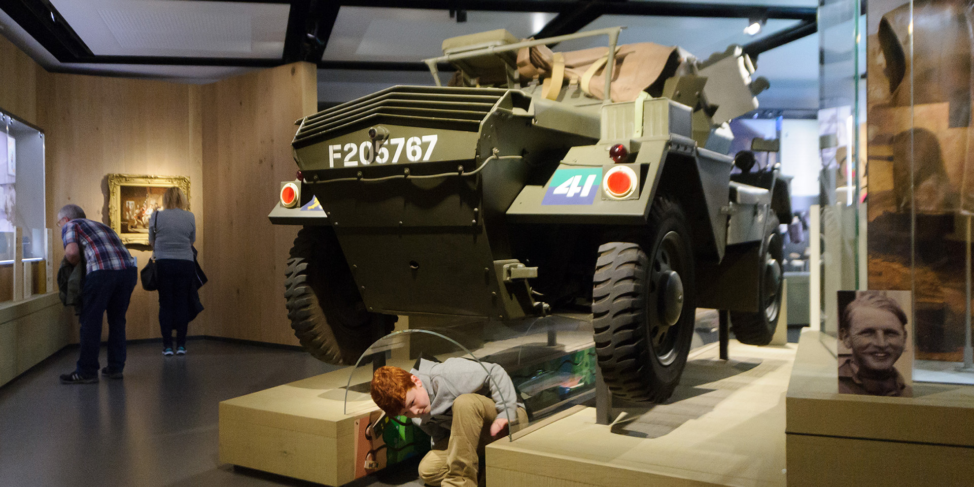 A child crawling under the Dingo scout car in Soldier gallery