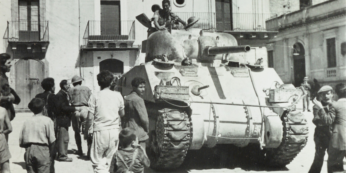 A Sherman tank passing through Francofonte, Sicily, 1943