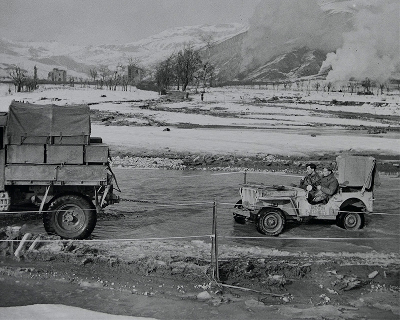 A truck towing a jeep out of the Sillaro River in Italy