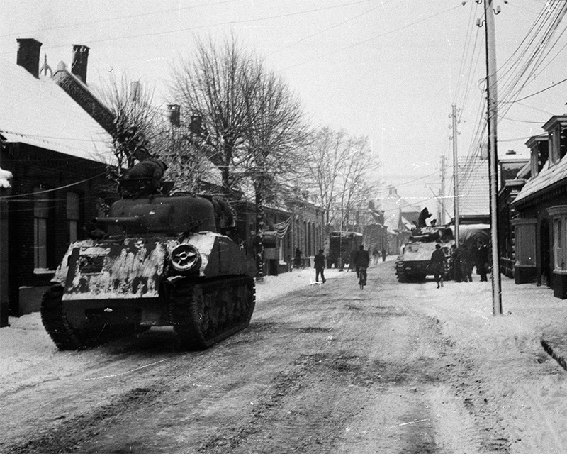 Sherman tanks unloading in the town of Asten in the Netherlands