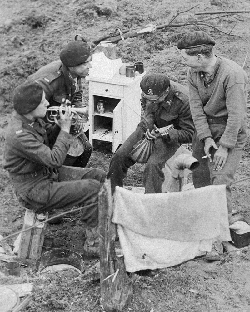 Members of a British tank crew playing musical instruments near Udem in Germany, 5 March 1945