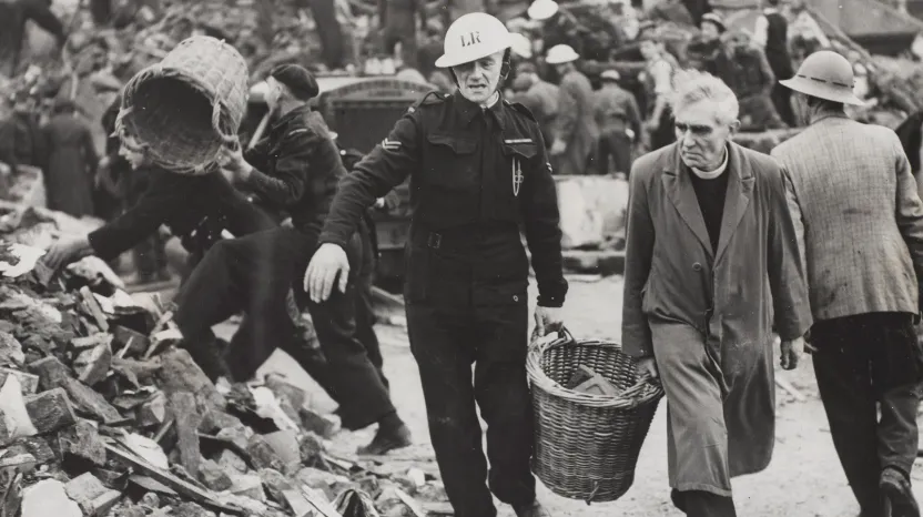 A clergyman and Civil Defence workers helping to clear the debris of a London school, 1940
