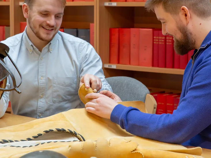 People feeling the textures of items in the handling collection