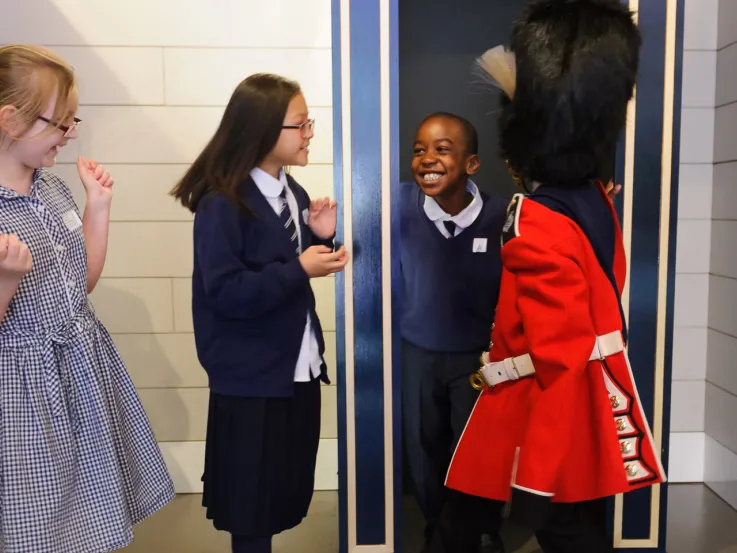 Kids trying on uniforms in Society gallery