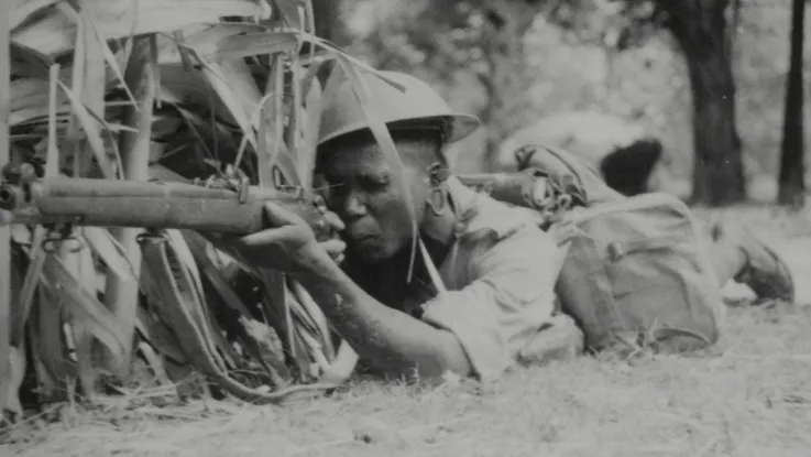 Soldier of the King’s African Rifles covering a road, armed with a Short Magazine Lee-Enfield Rifle, c1943