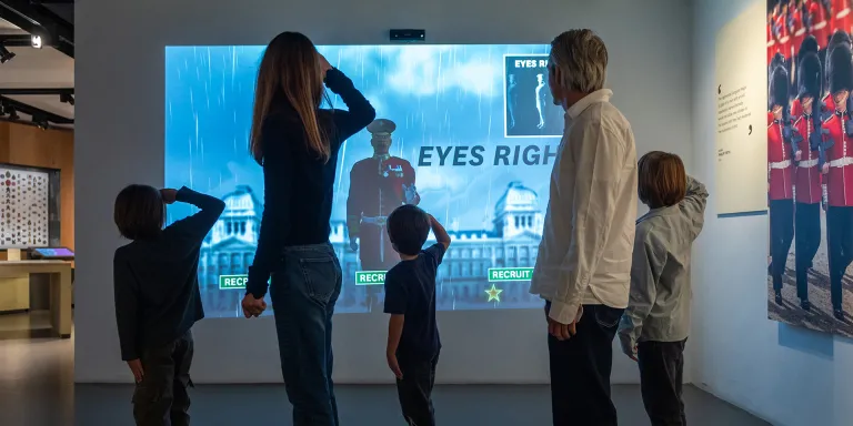 A family being put through their paces by the virtual drill sergeant in Soldier gallery